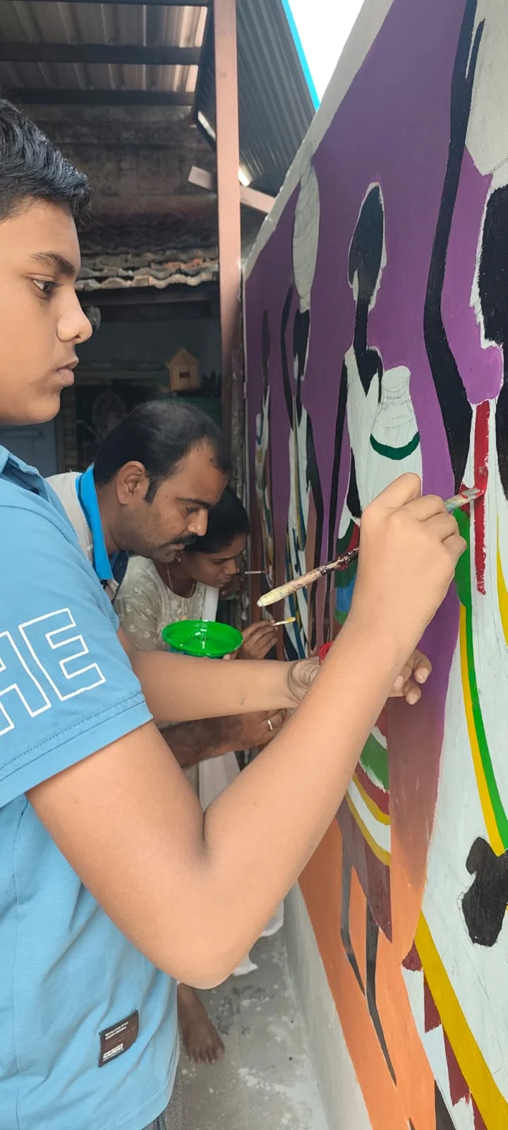 Student painting a mural